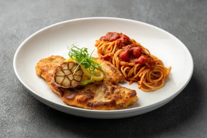 Crispy chicken alla Milanese served with fresh lemon wedges at Secret Oven Koh Samui