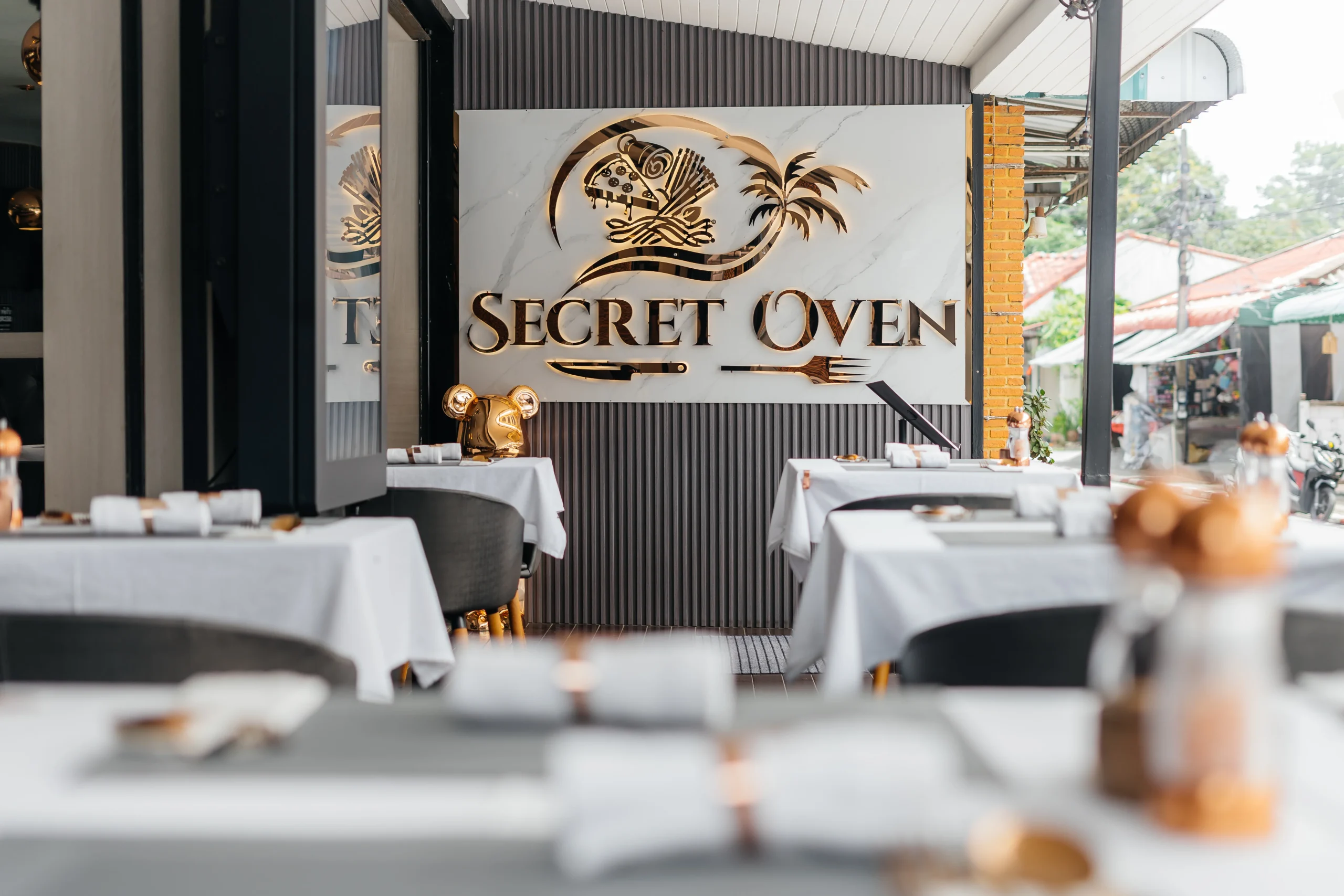 Secret Oven Koh Samui’s stylish dining room featuring handcrafted tables and soft lighting
