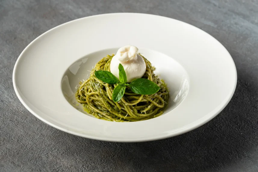 Fresh pasta tossed in basil pesto sauce topped with creamy burrata at Secret Oven Koh Samui