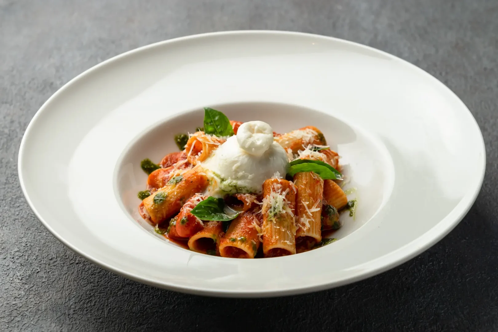 Italian rigatoni pasta with basil tomato sauce topped with creamy burrata at Secret Oven Koh Samui