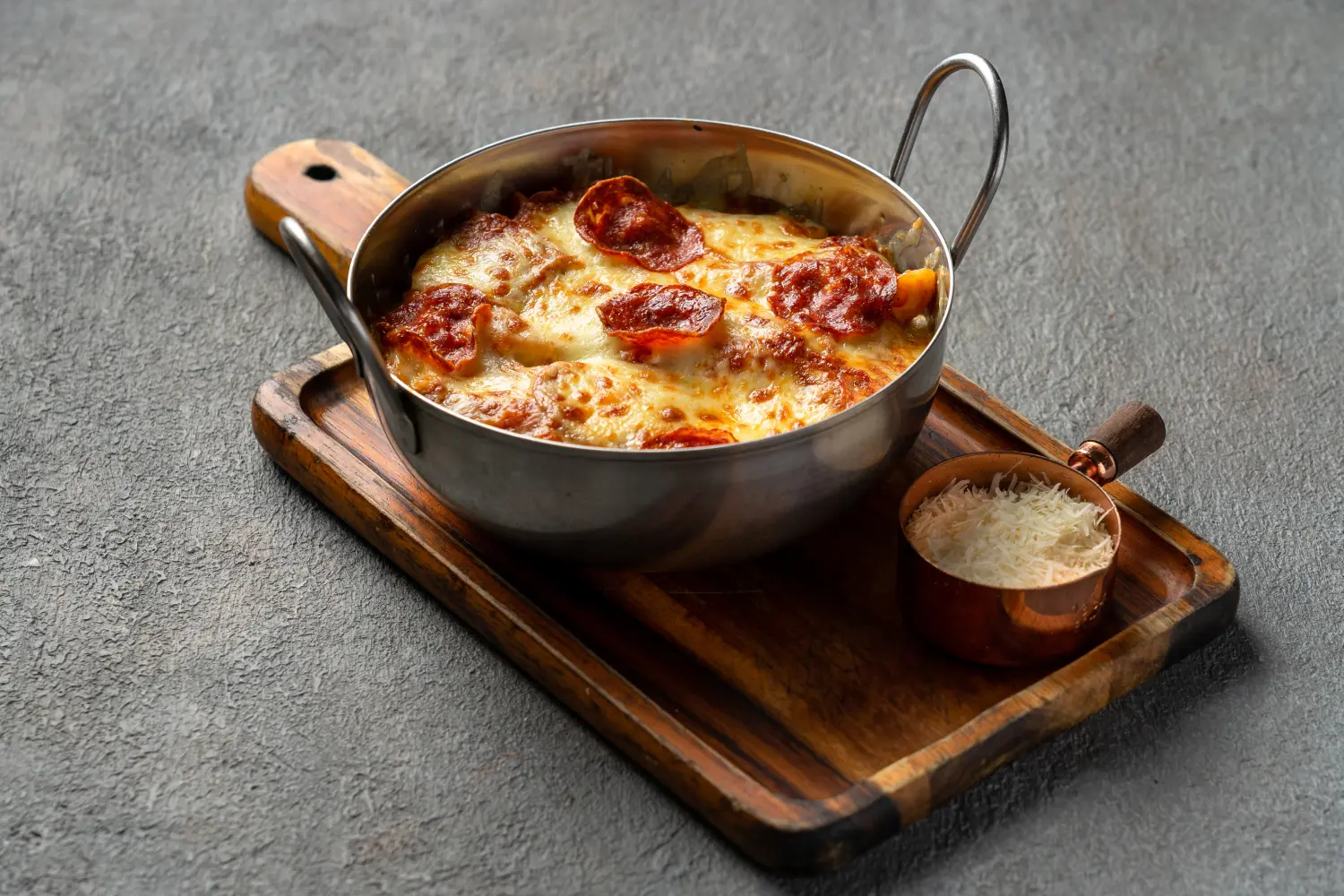 Close-up of cheesy baked penne calabrese pasta fresh from the oven at Secret Oven Koh Samui